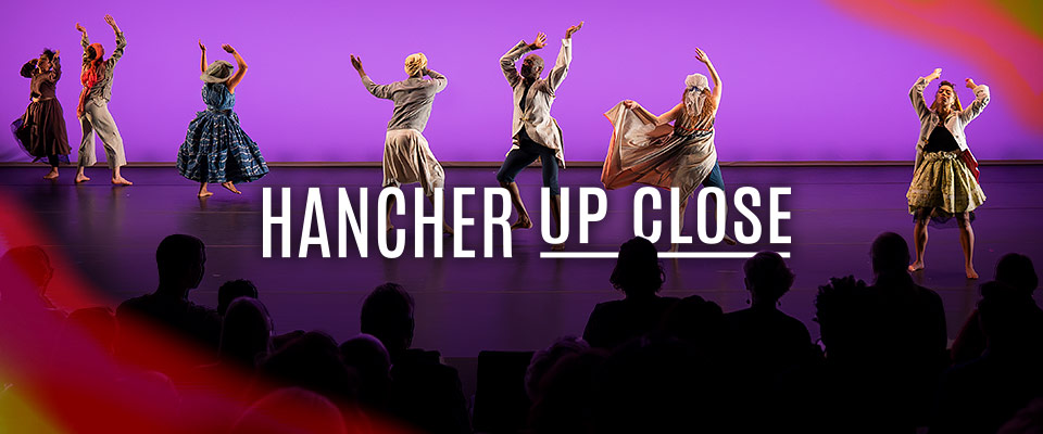 Group of dancers performing on stage in Hancher Up Close configuration with audience silhouettes on stage in the foreground