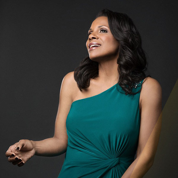 Portrait of Audra McDonald wearing a teal one-shoulder dress