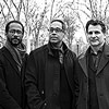 Black and white photo of Children of the Light artists, Danilo Pérez, John Patitucci, and Brian Blade 