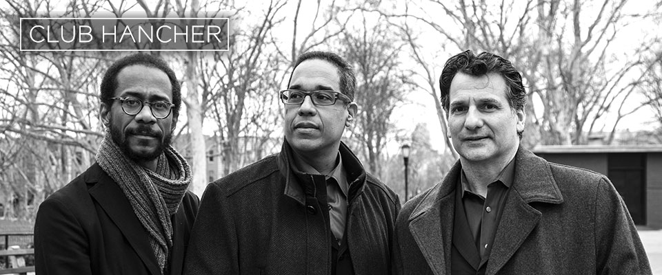 Black and white photo of Children of the Light artists, Danilo Pérez, John Patitucci, and Brian Blade 