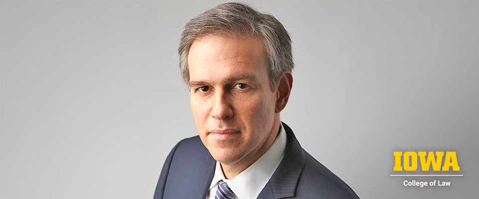Brett Stephens headshot with UIowa Law logo in bottom right corner