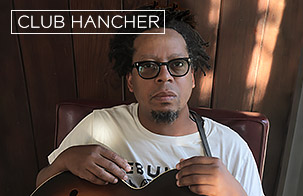 Jeff Parker headshot with his guitar in his lap
