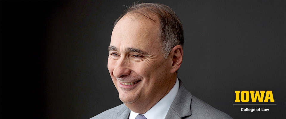 David Axelrod headshot with UIowa Law logo in bottom right corner