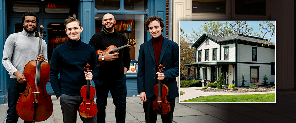Isidore String Quartet Isidore String Quartet standing looking at the camera while holding their insturments