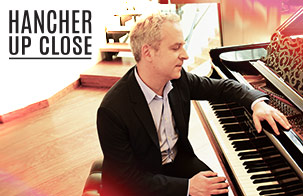 Jeremy Denk: Colored photo of Jeremy Denk sitting at a piano