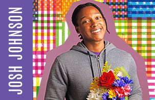 Josh Johnson standing against the Infinite Dream flag treatment. Johnson is holding a bouquet of flowers