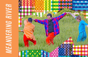Meandering River Meandering River: Two dancers holding hands in movement in a grassy field