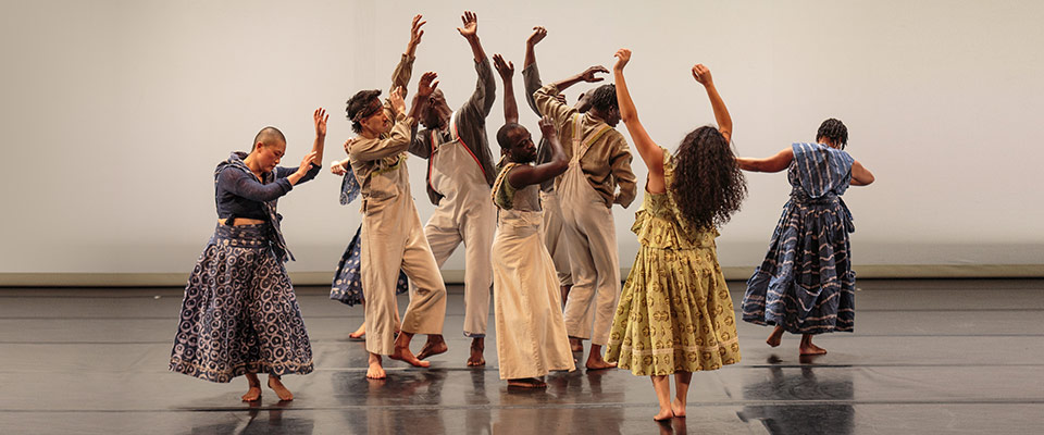 Fist and Heel Performance group dancing on stage in muted wardrobe colors