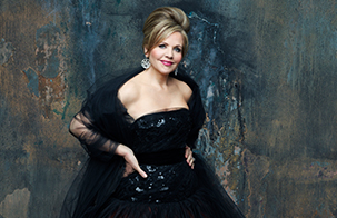 Renée Fleming with her hands on her hips facing the camera
