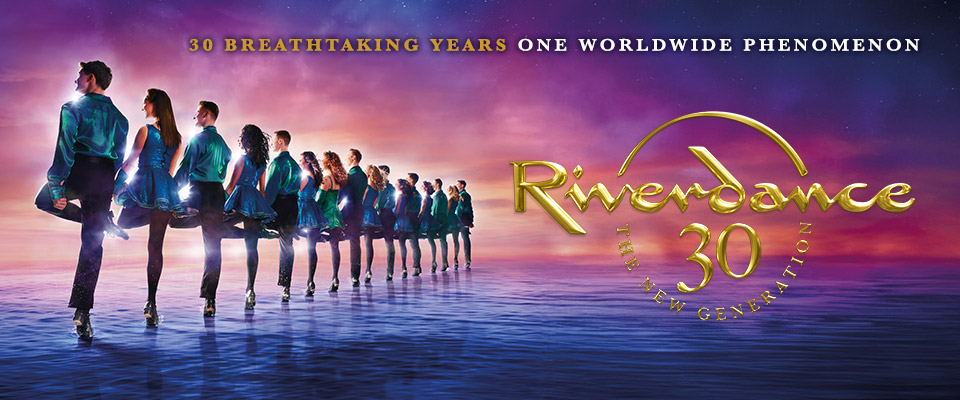 Riverdance banner photo: Dancers lined up with gold text Riverdance 30 