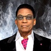 Headshot of Herbie Hancock in front of a smoky background