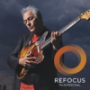 Marc Ribot playing guitar against a grey background. Refocus Fillm Festival logo in lower right corner