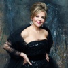 Renée Fleming with her hands on her hips facing the camera