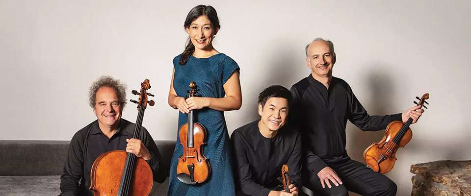 Takács Quartet members posing with their instruments