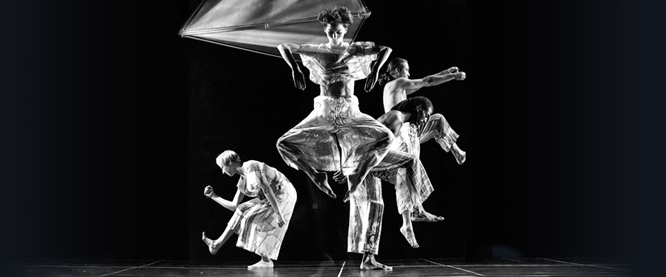 Trisha Brown Dance Company dancers in movement. Photo is in black and white
