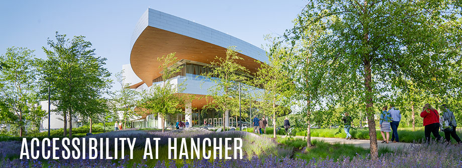 Image of Hancher exterior with flowers in full bloom. Text "Accessibility at Hancher" in lower left corner