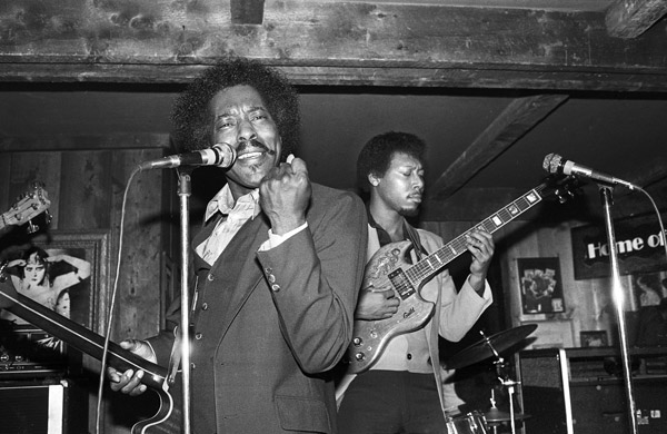 Black and white photo of Buddy Guy playing a gig