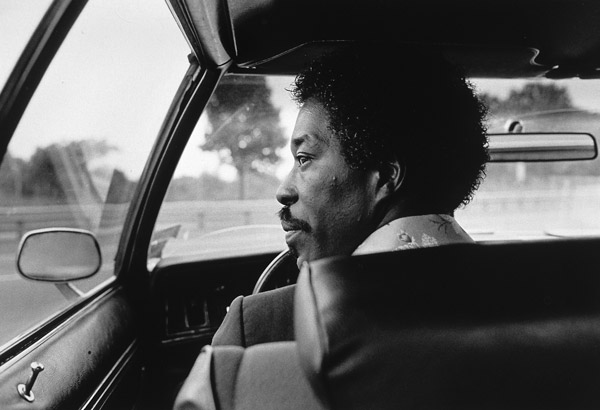 Black and white photo of Buddy Guy driving to a gig