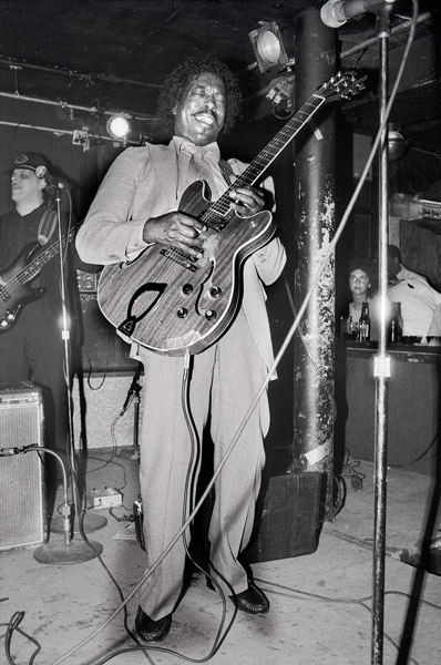 Black and white photo of Buddy Guy playing a gig