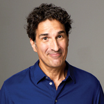 Gary Gulman weaking blue button down close-lipped smiling straight on at the camera. Club Hancher text treatment in upper left corner
