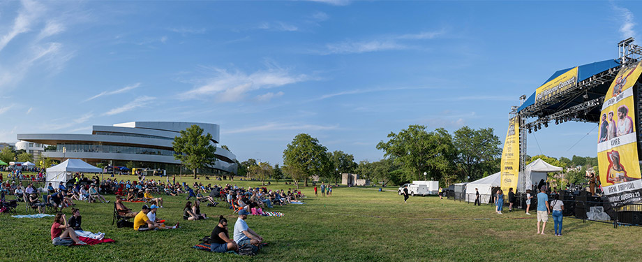 The Hancher Green A panoramic photo of the Hancher green with a stage set up on the right for the Fall Welcome Concert, and Hancher Auditorium in the background on the left