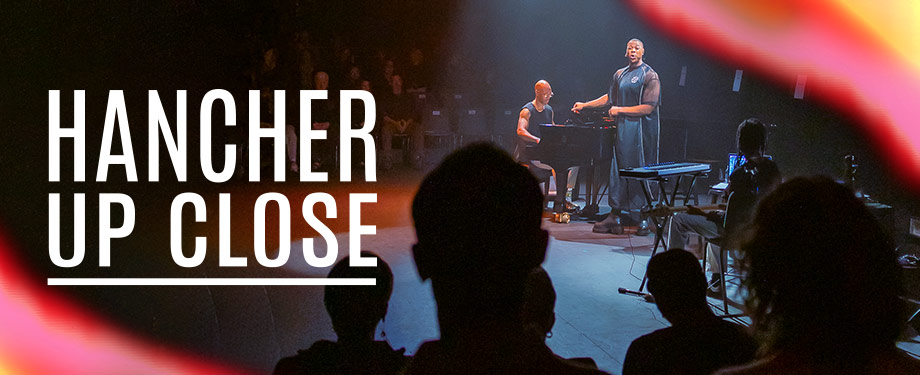 Hancher Up Close (Photo: Jason Smith) A photo of a performance on stage. An audience sits on raised seats, surrounding artist Davone Tines. Text reads: "Hancher Up Close"