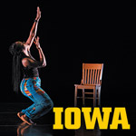 International Writing Program & Dance Collaboration UI dancer on stage in a movement next to a chair
