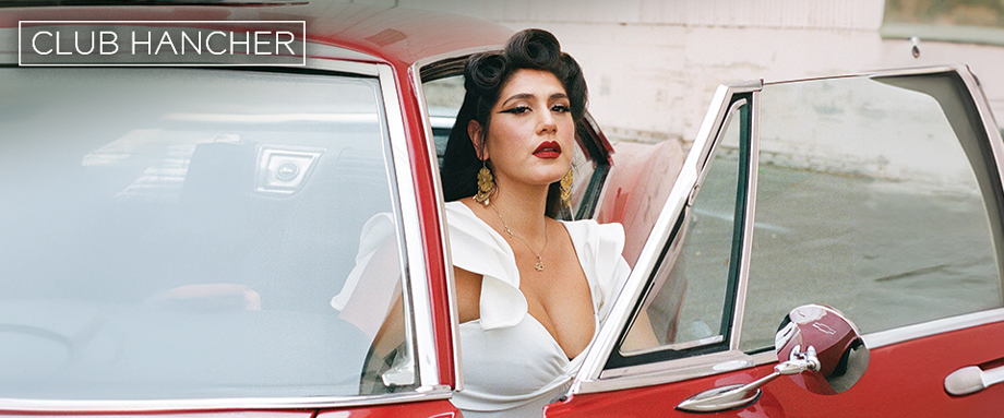 La Dona exiting a red car in a white dress with Club Hancher text treatment in upper left corner