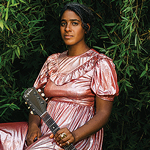 Leyla McCalla sitting in a pink dress against greenery holding her guitar to her left side. Club Hancher text treatment in upper left corner